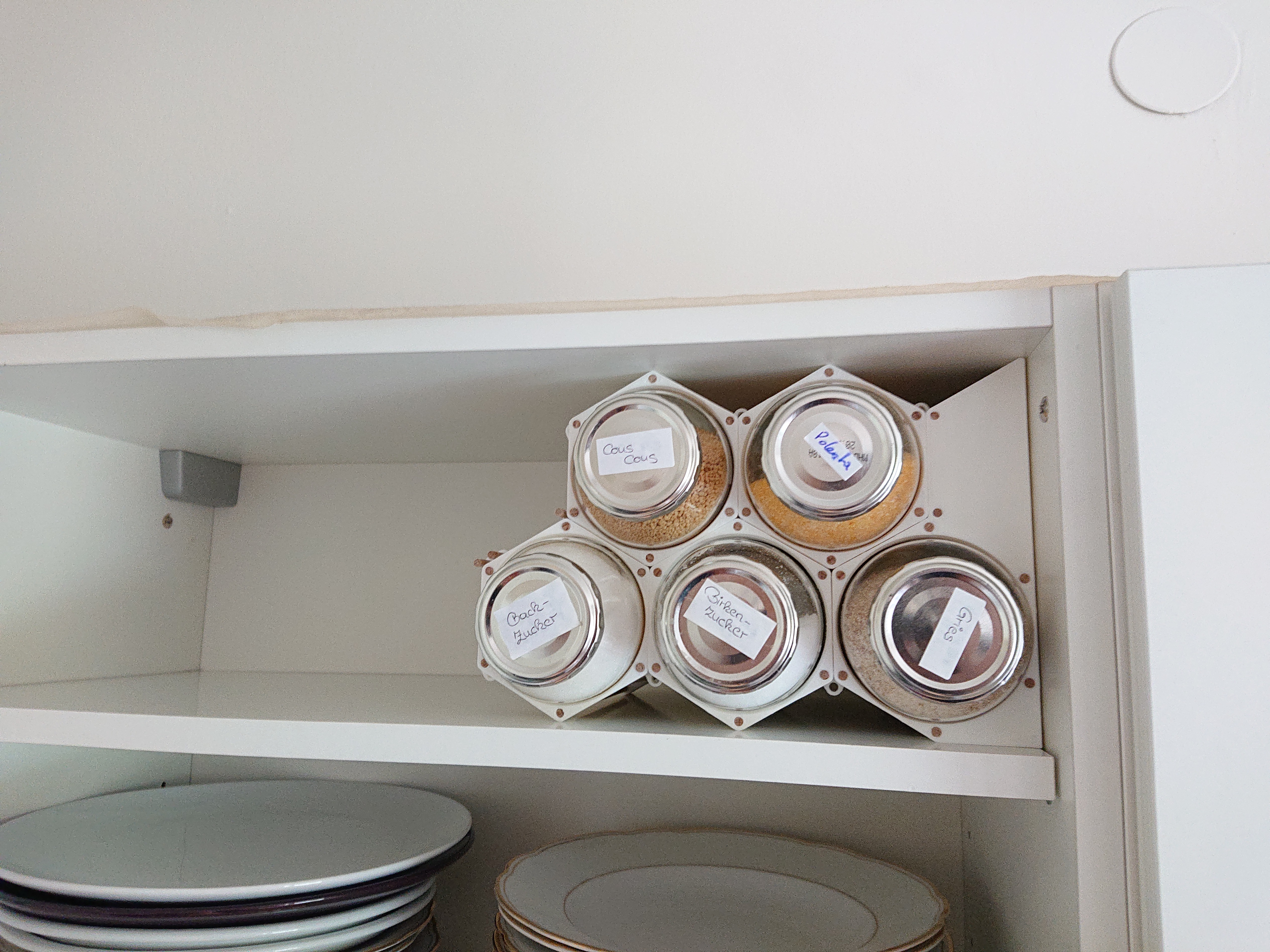 Modular kitchen storage using upcycled glass bottles. - photo 4